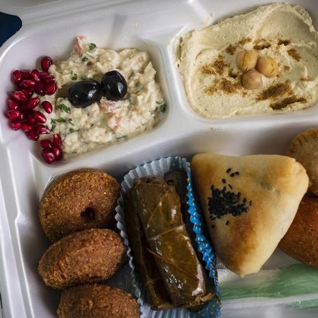 Image of Takeout containers of Syrian delicacies were distributed to guests of a virtual dinner.